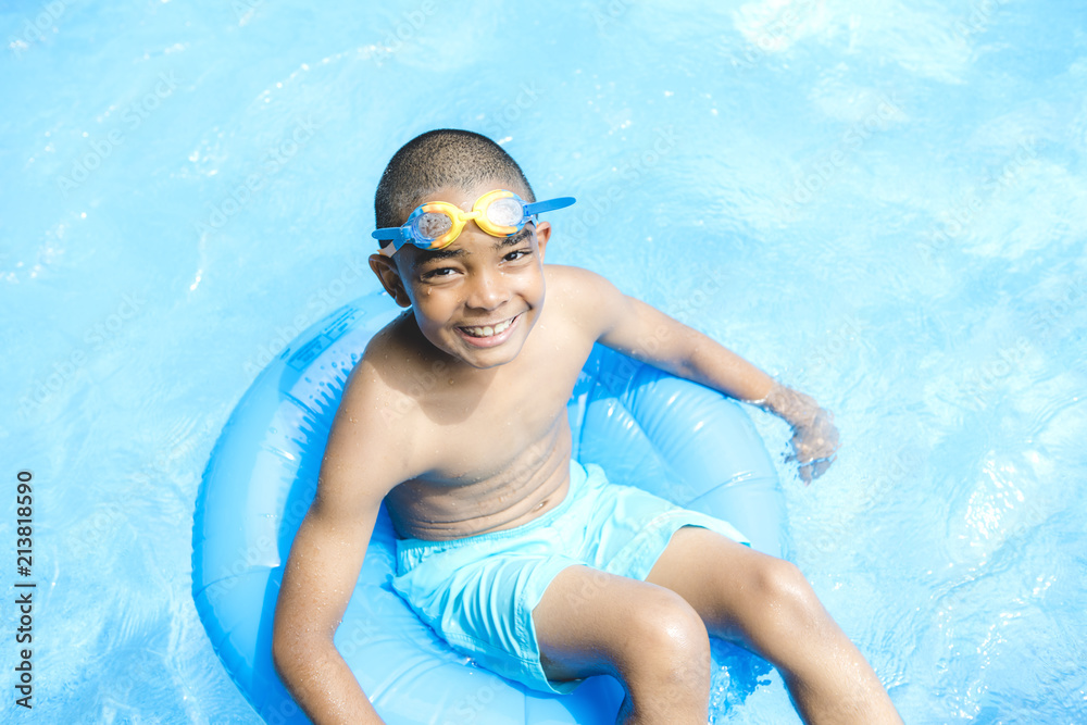 Portrait of boy having good time in swimming pool