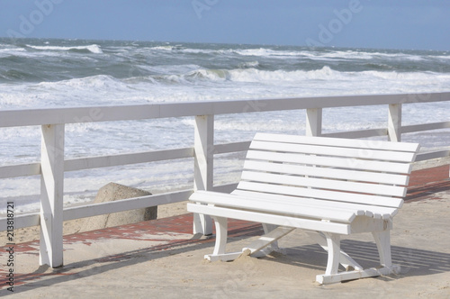 White bench on the beach promenade by jziprian photo