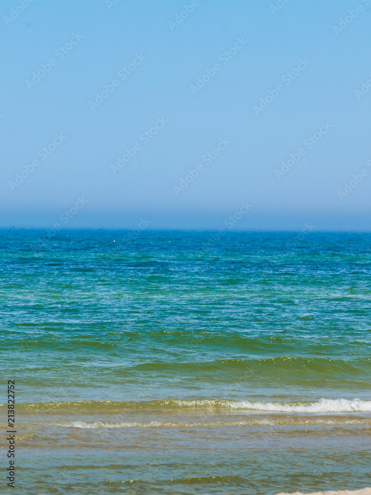 Blue sea water horizon and sky.
