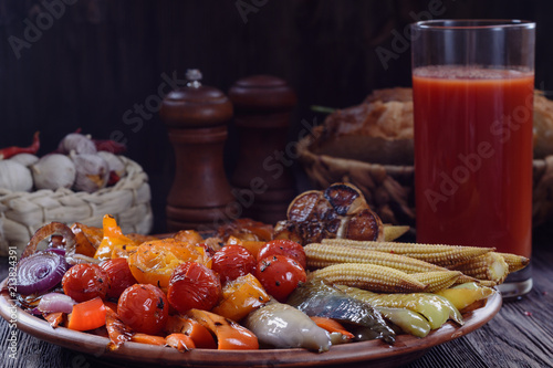 Appetizing fried vegetables with sauce and spices on a wooden table