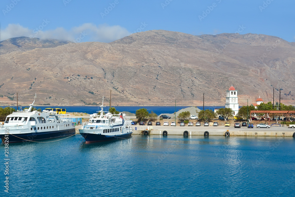 A wharf in a small Greek port in the early morning. Pleasure boats in a small port