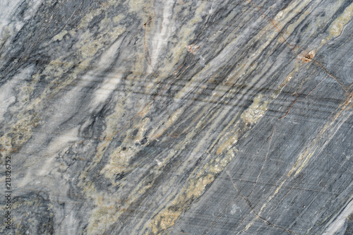 Gray surface of marble stone with striped streaks.