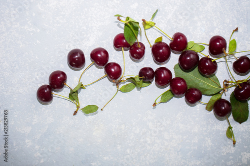 Top view of ripe red cherry on a light gray background, close up photo