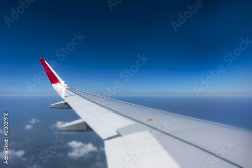 selective focus Airplan wing above the blue sky