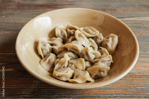 Boiled dumplings on a ceramic plate on a table