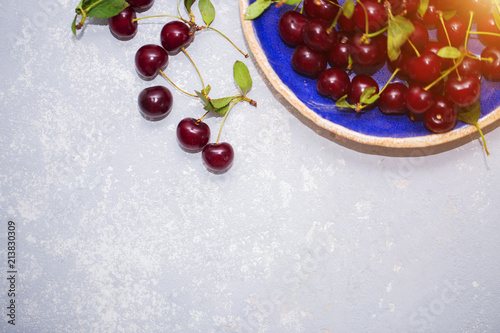 Beautiful texture, background with ripe cherries in a plate, top view photo
