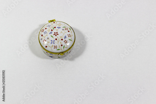 Ornamented shinny reflective single white pill box with white background01 photo