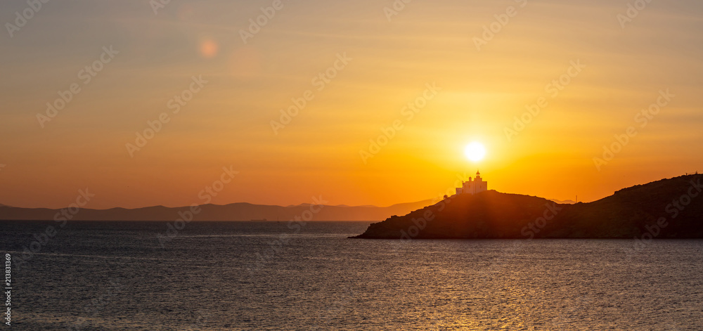 Mediterranean sea. Beautiful sunset and a lighthouse at Kea island, Greece.