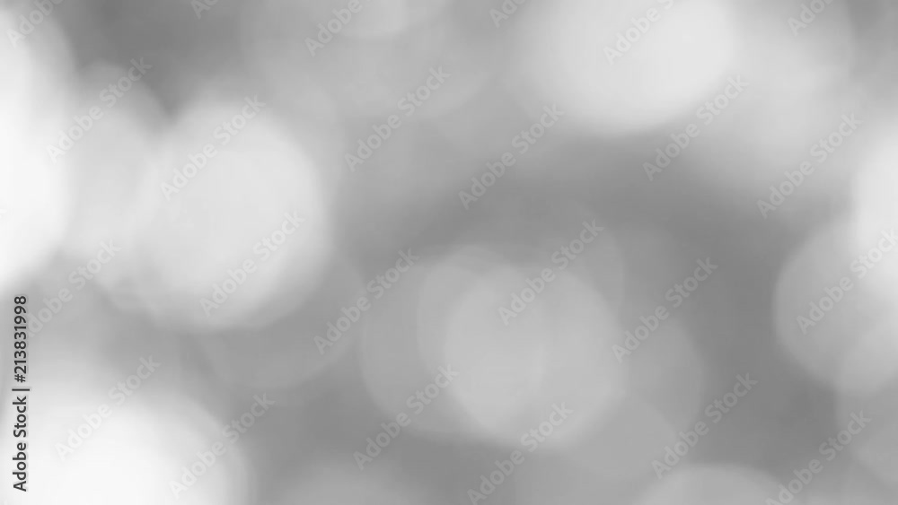 Black and white light bokeh nature background of out of focus fresh green leaves isolated at sky on summer sunny morning. Real time full hd video footage.