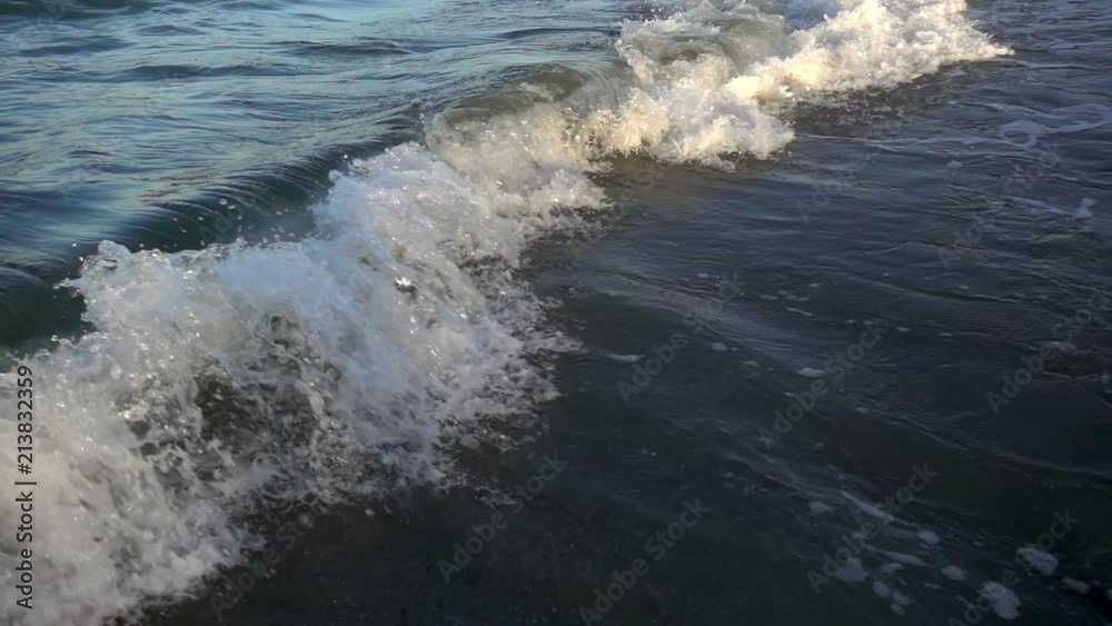 Slow motion of a large sea wave with foam and spray rushes to the shore. Slow motion of a large sea wave with foam and spray rushes to the shore.