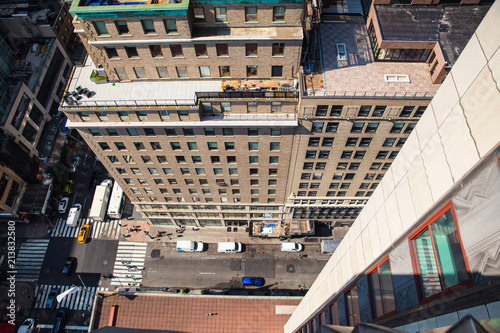Downwards view from the ledge of a building in New York City with street below in view