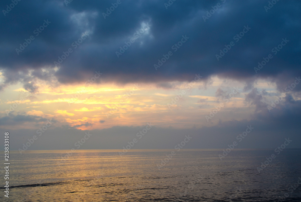 Light mood with orange illuminated clouds during a sunrise over the Baltic Sea in Bansin on usedom, Germany