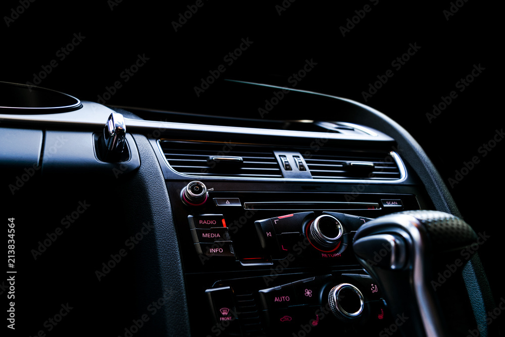 Obraz premium Modern Luxury sport car inside. Interior of prestige car. Black Leather. Car detailing. Dashboard. Media, climate and navigation control buttons. Sound system. Modern car interior details