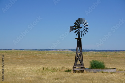 Windmill pumping water on the plains