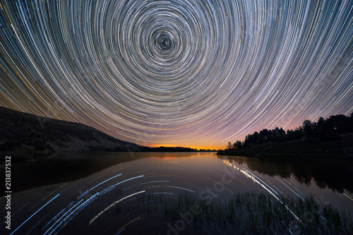 Star trails over Laguna Grande in neila, Burgos, Spain photo