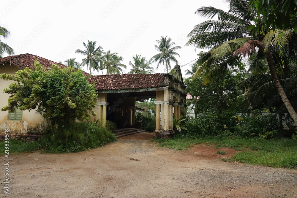 Aluthgama, Sri Lanka - May 04, 2018: Exterior view of the old house with columns of 1898 year of construction in Sri Lanka