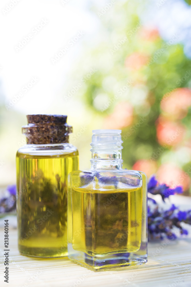 oil jars or lavender essence with a bouquet of natural lavender flowers oil jars or lavender essence with a bouquet of natural lavender flowers