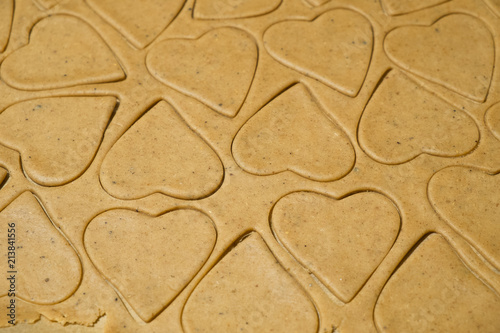 Homemade Gingerbread Cookies cut into Christmas heart shapes ready for baking