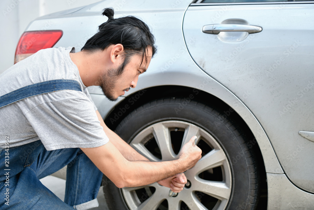 Car Repair Concept. Asian people are repairing cars on the roadside. Asian guy fixes car with confidence Car Repair Concept. Asian people are repairing cars on the roadside. Asian guy fixes car with confidence