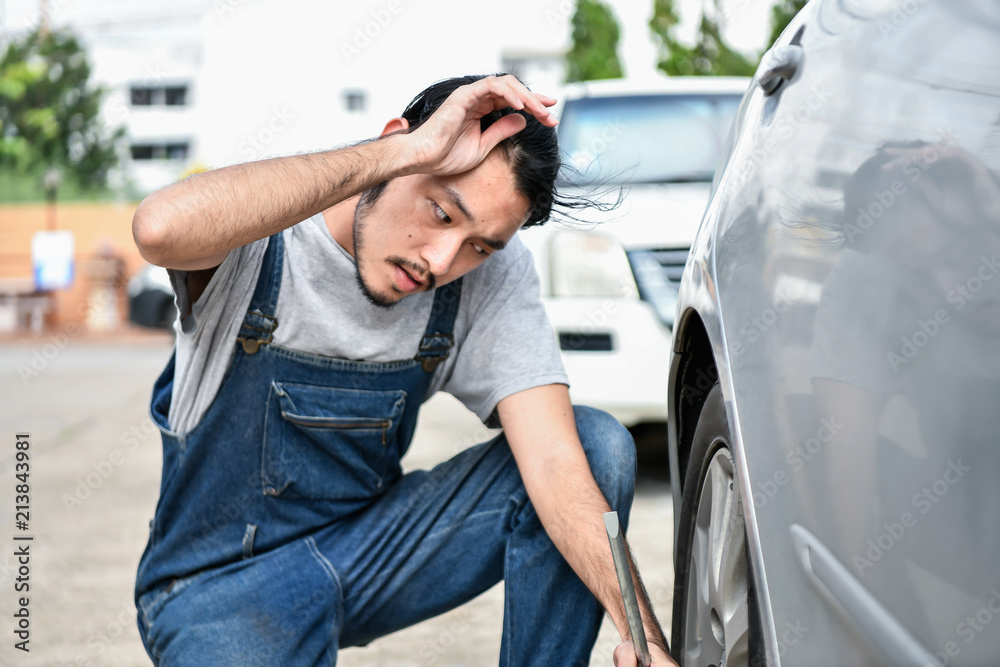 Car Repair Concept. Asian people are repairing cars on the roadside