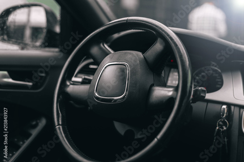 interior, the steering wheel of a luxury car. black leather trim. © velimir