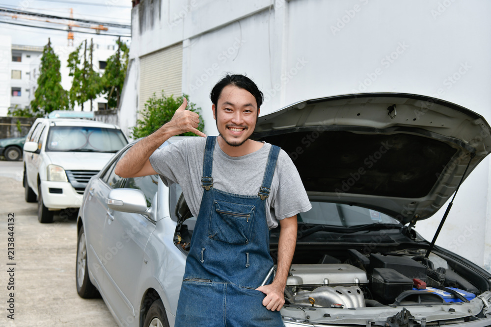 Car Repair Concept. Asian people are repairing cars on the roadside