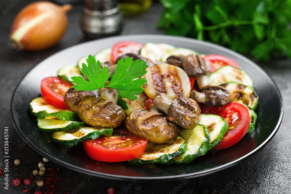 Salad with fresh and grilled vegetables and mushrooms. Vegetable salad with grilled champignons. Vegetable salad on plate Salad with fresh and grilled vegetables and mushrooms. Vegetable salad with grilled champignons. Vegetable salad on plate
