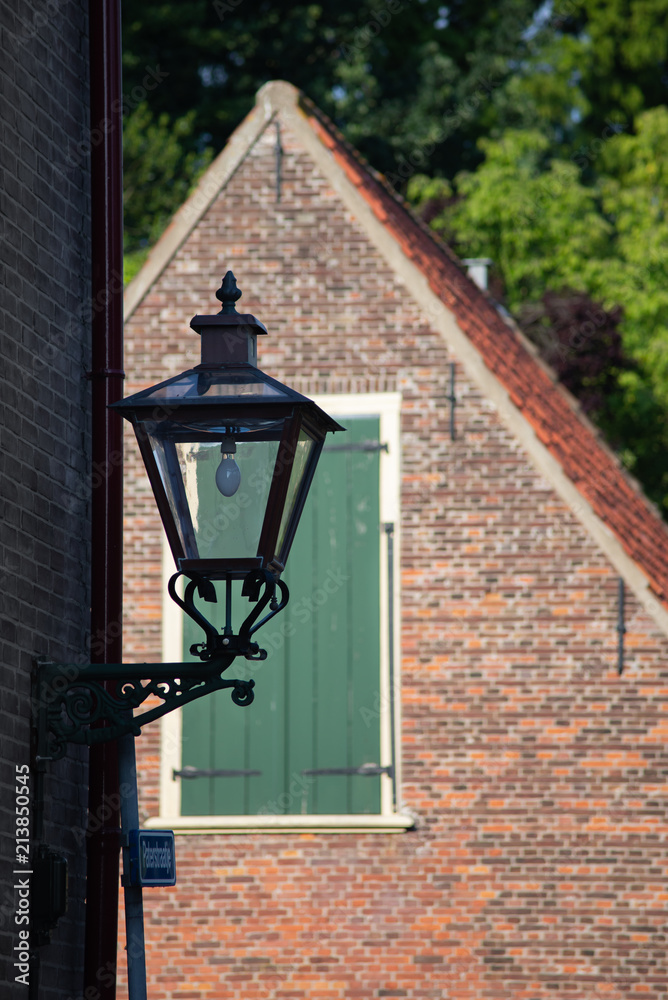 Street lamp, window with green blinds and red roof Street lamp, window with green blinds and red roof