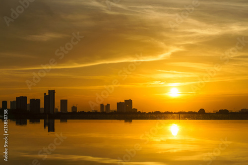 Beautiful golden sunset over the infinity pool and skyline