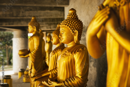 golden statue of a buddhist monk - close-up of praying holy spiritual statue with copy space