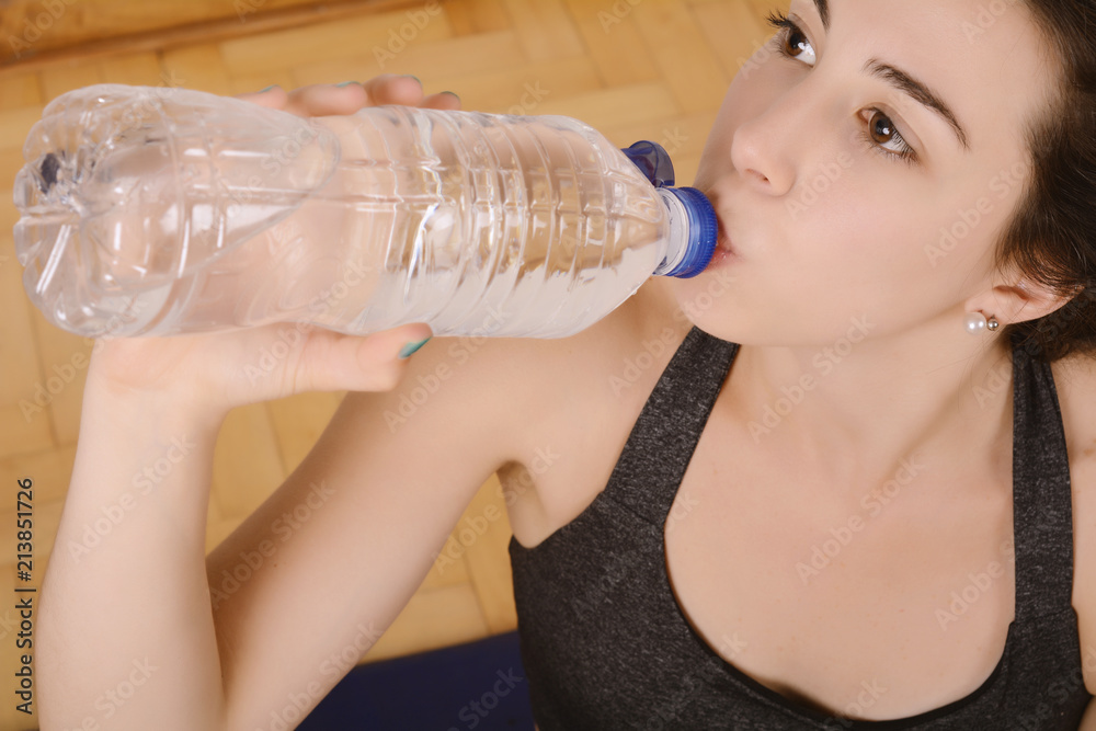 Close up view of sporty woman drinking water Close up view of sporty woman drinking water