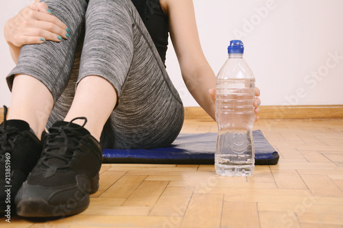 Close up view of sporty woman drinking water