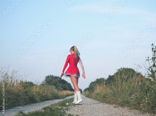 Teen Majorette Girl Twirling Baton Outdoors