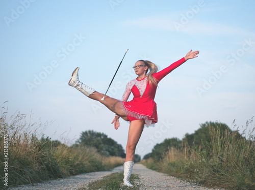 Teen Majorette Girl Twirling Baton Outdoors