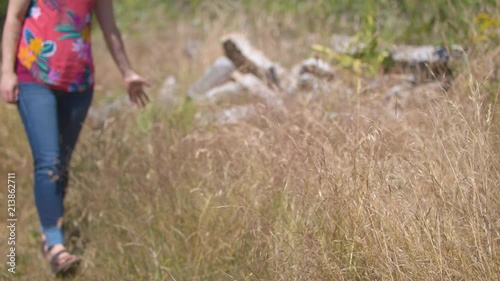 Wallpaper Mural Woman walking towards the camera through a field with rubble.  Shot on a Blackmagic Ursa Mini Pro 4.6k with a Sigma 50-100mm f/1.8. Torontodigital.ca