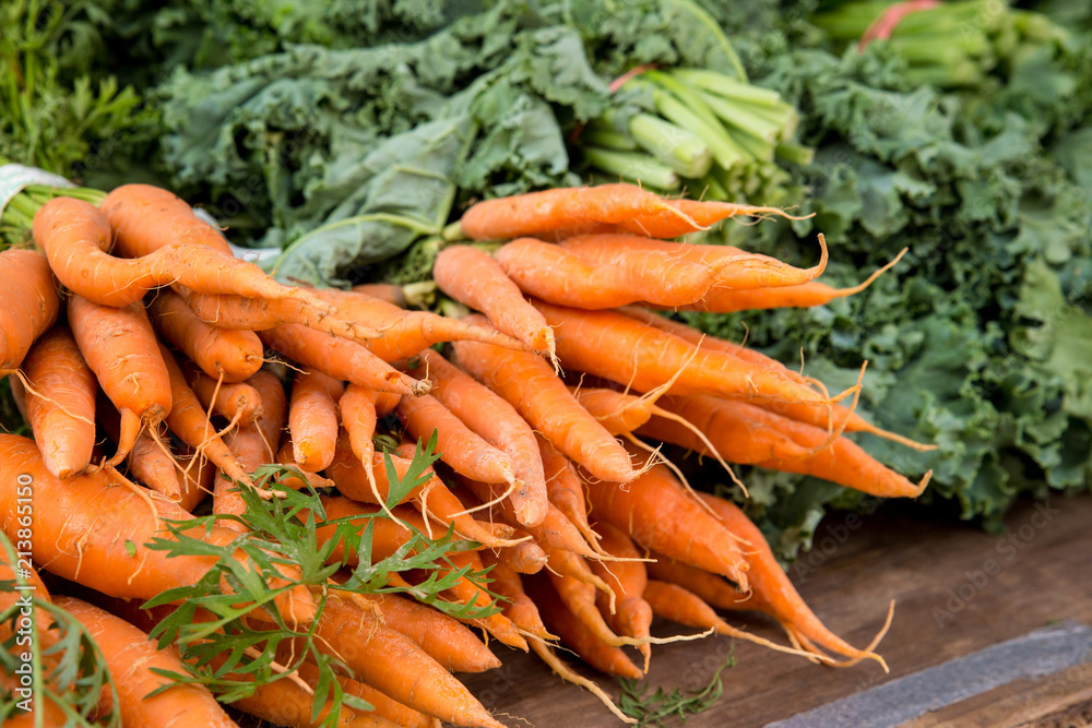 Crop of organically grown carrots on display at farmers market Crop of organically grown carrots on display at farmers market
