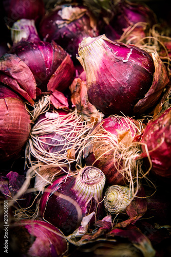 Crop of raw red Bermuda onions at farmers market