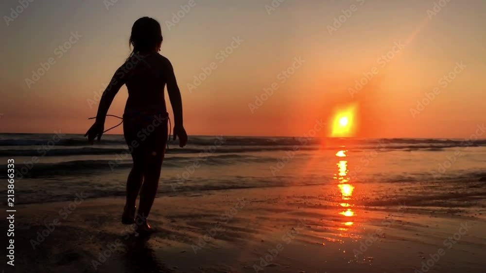 Happy young girl enjoying freedom with open hands on sea. Cheering girl hiker open arms at sunset seaside beach. Happy young girl enjoying freedom with open hands on sea. Cheering girl hiker open arms at sunset seaside beach.