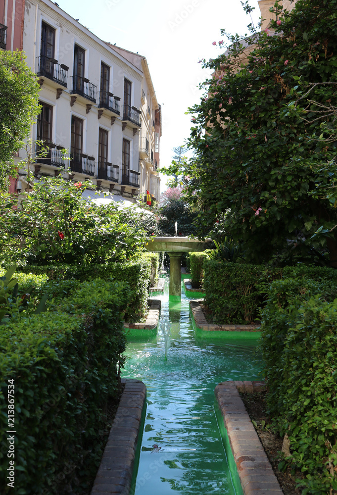 Nice green garden with a little fountain in Malaga, Spain