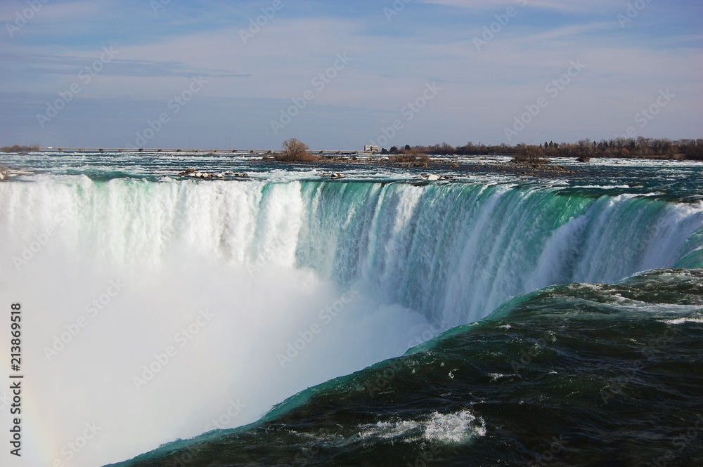 Niagara Falls under rainbow in early spring, New York State, USA.