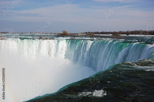 Niagara Falls under rainbow in early spring, New York State, USA.