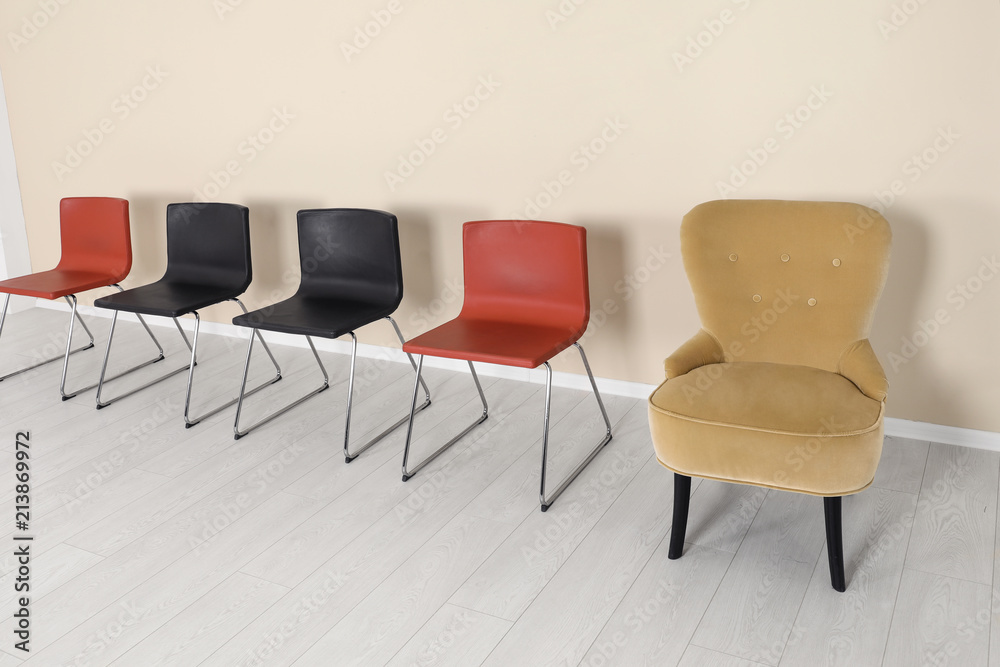 Fototapeta premium Comfortable armchair and chairs indoors. Interior decor elements