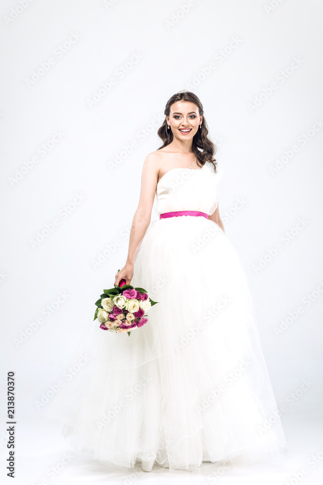 smiling young bride in wedding dress with bouquet on white smiling young bride in wedding dress with bouquet on white