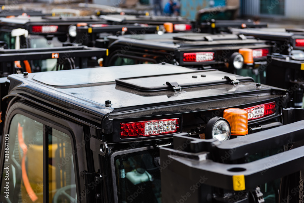 Fototapeta premium Black roofs of new electric forklift cars