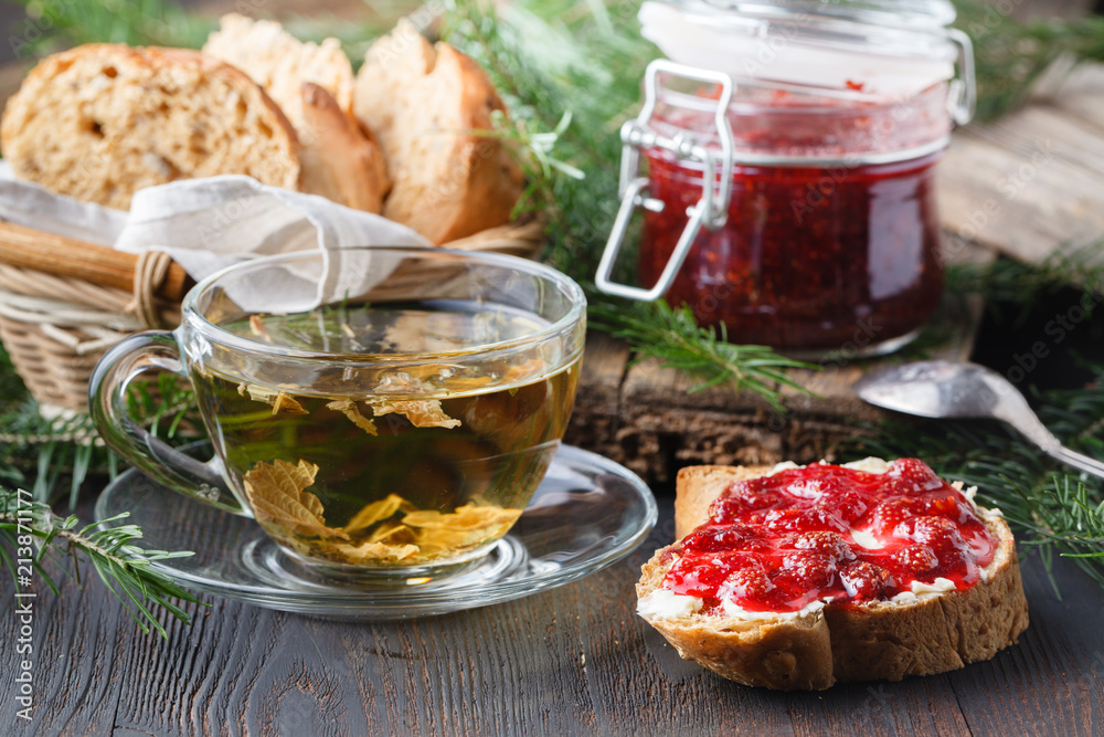 Cup of tea with berry jam on old wooden table Cup of tea with berry jam on old wooden table