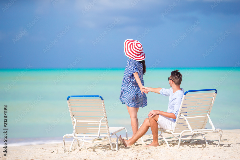 Couple relax on a tropical beach at Maldives