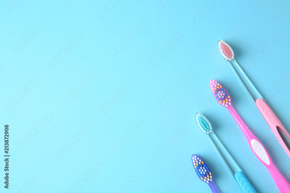 Flat lay composition with manual toothbrushes on color background Flat lay composition with manual toothbrushes on color background