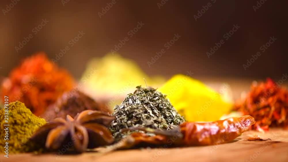 Spice. Various Indian spices and herbs rotated on wooden table. 4K UHD video 3840x2160