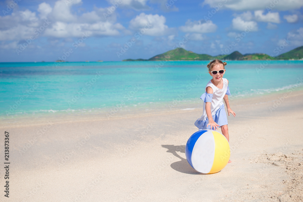 Little adorable girl playing on beach with ball Little adorable girl playing on beach with ball