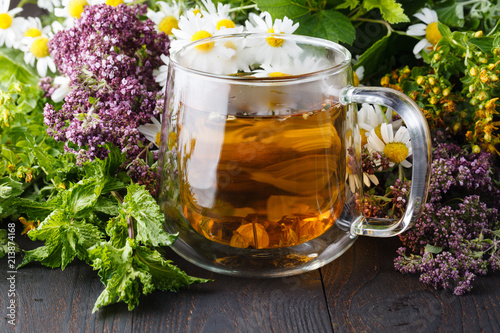 cup of tea with oregano herb on wooden table